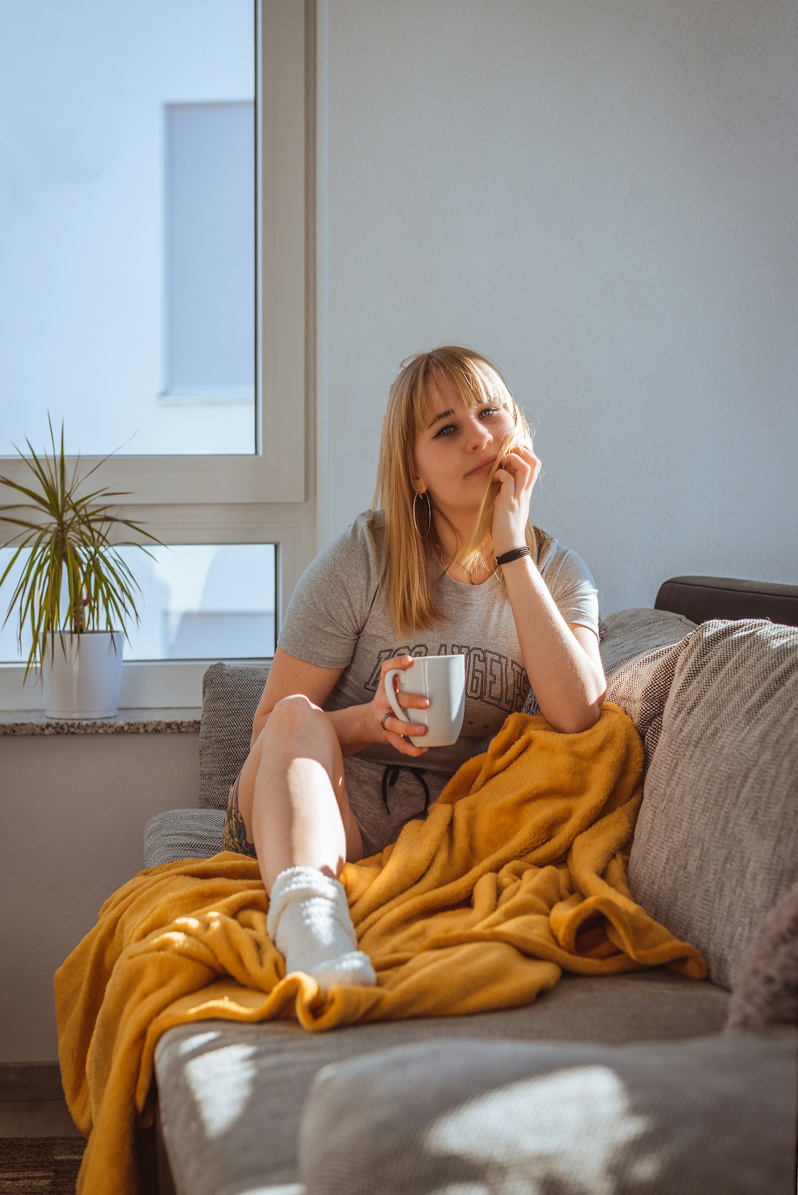 Woman relaxing on her sofa with a mug